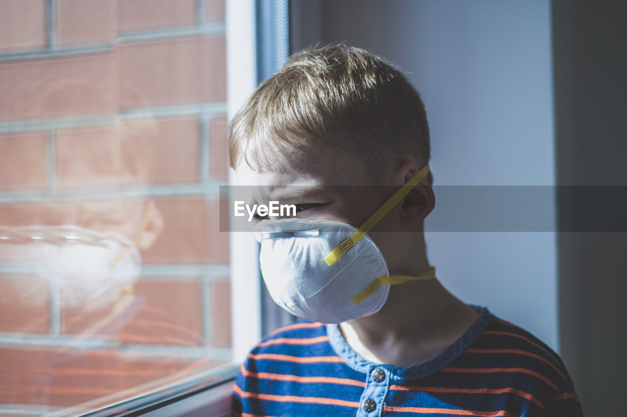 Portrait of boy drinking from window