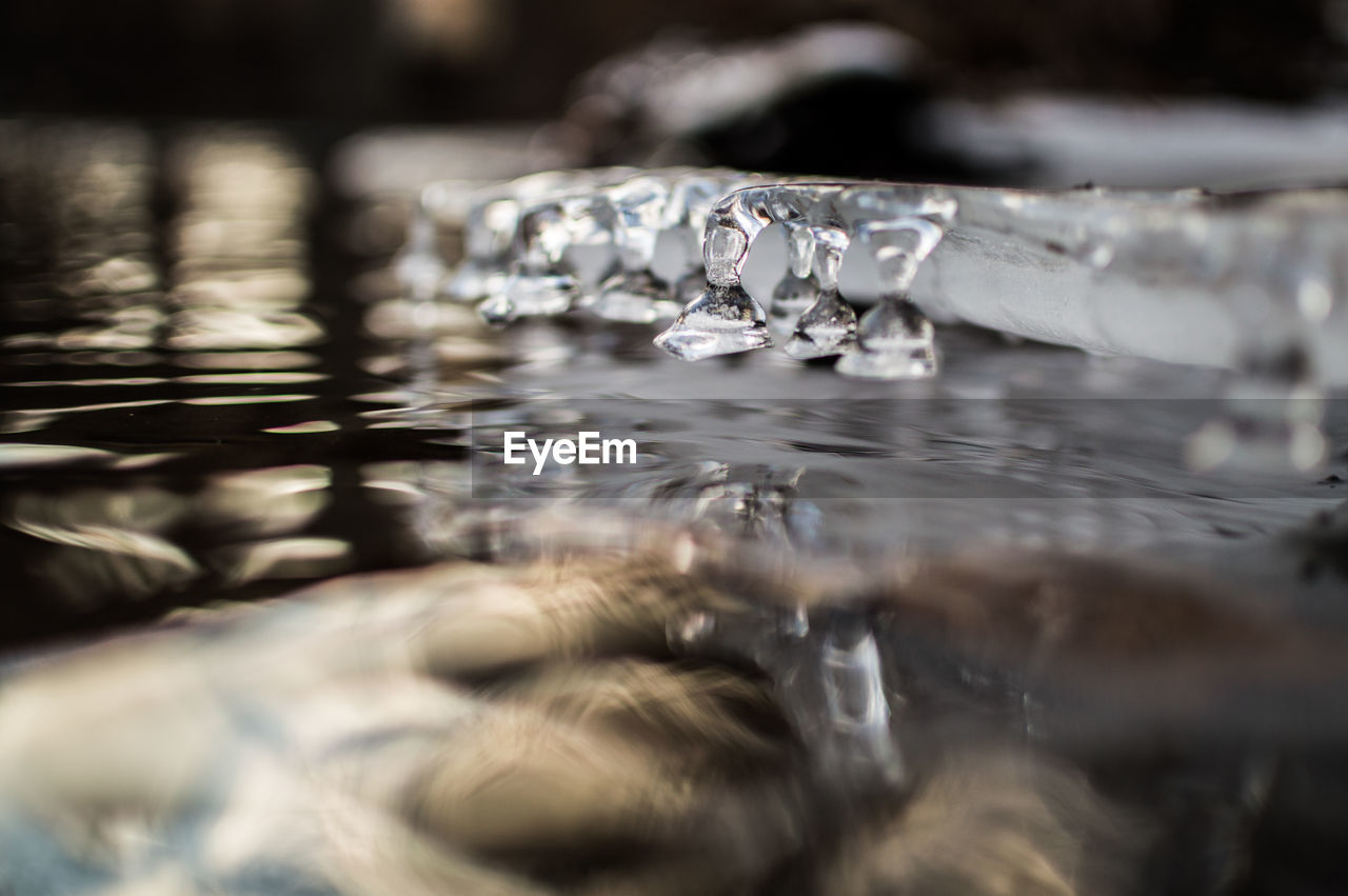 CLOSE-UP OF WATER DROP ON ICE