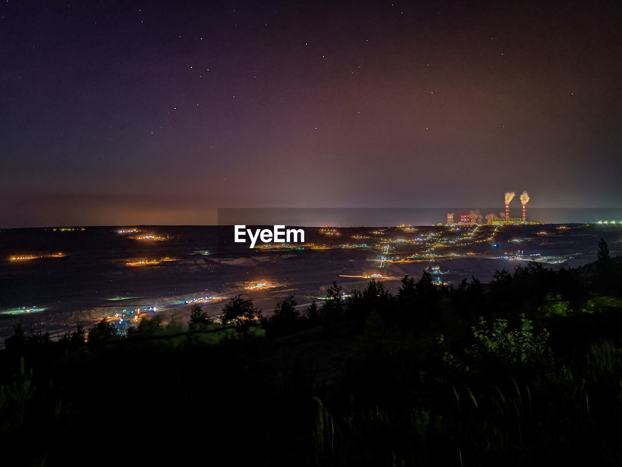 High angle view of illuminated buildings in city at night