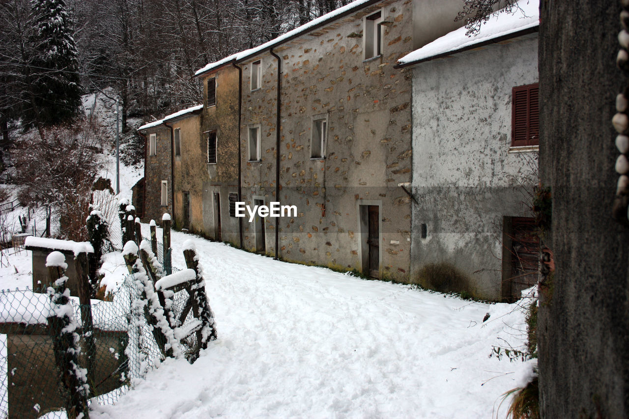 Abandoned village in white snowy mountain peak in reverse in the forest in tuscany