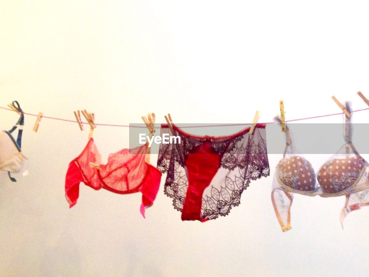 CLOSE-UP OF CLOTHES DRYING HANGING ON CLOTHESLINE