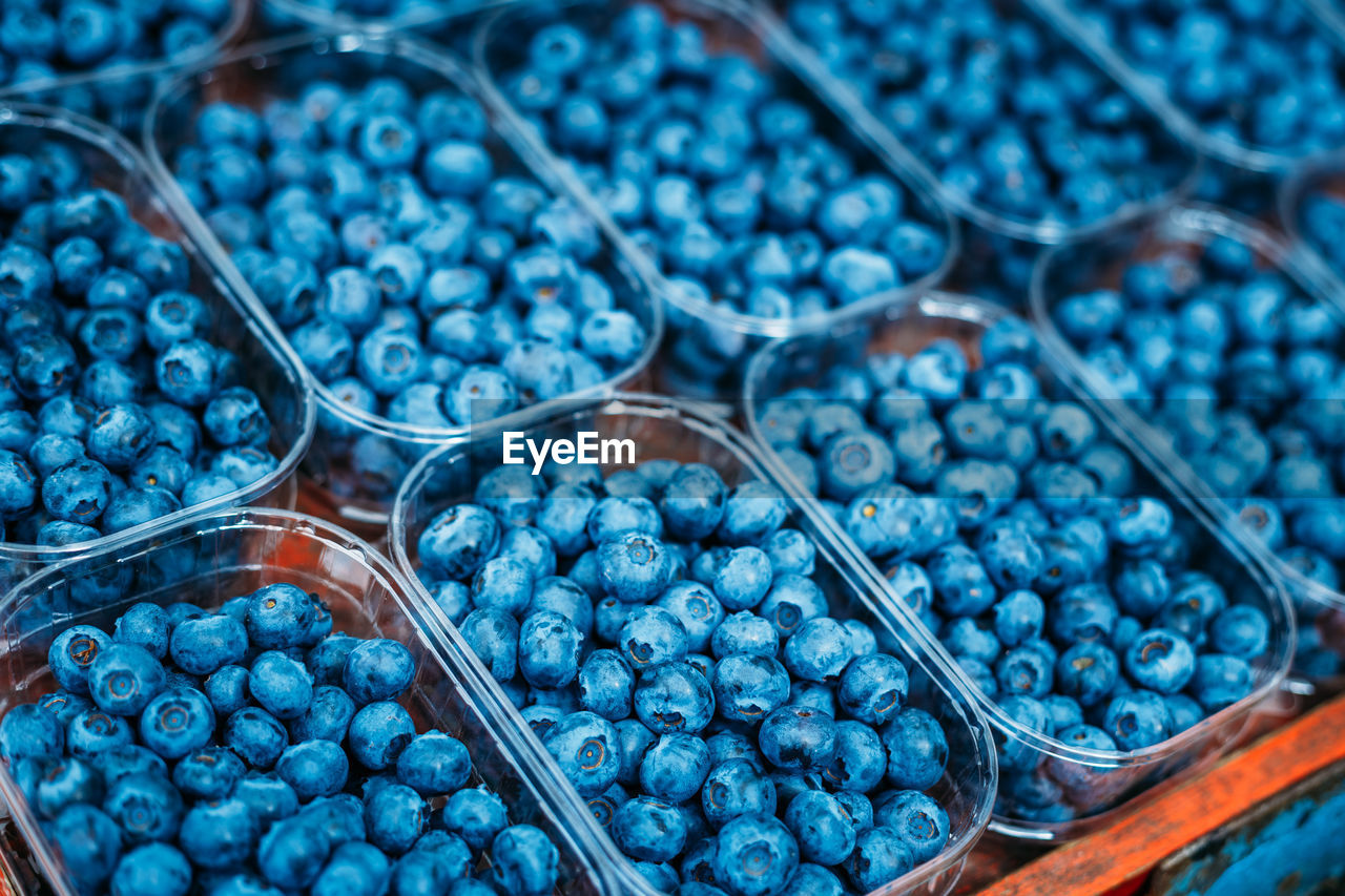 Close-up of blueberries in containers for sale at market