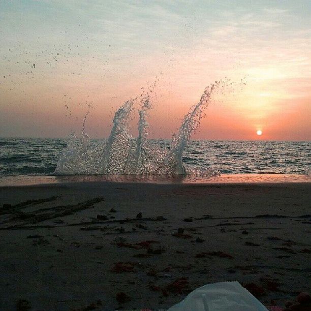 CLOSE-UP OF SEA SHORE AGAINST SKY DURING SUNSET