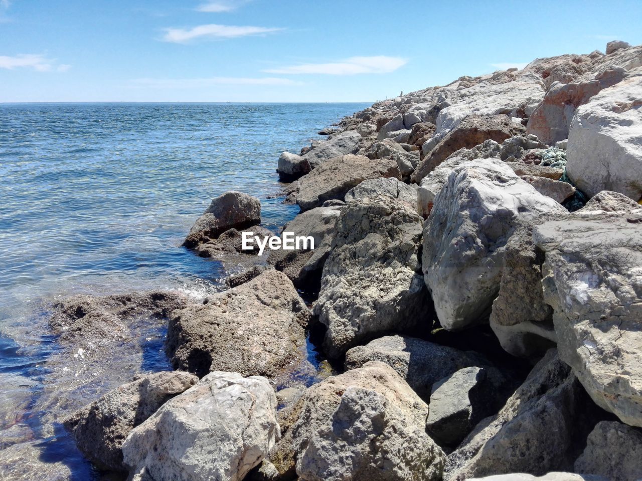 Scenic view of calm sea against blue sky
