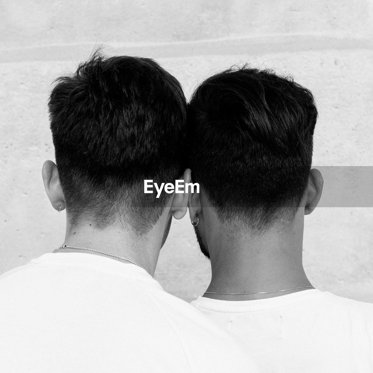 Rear view of couple against wall