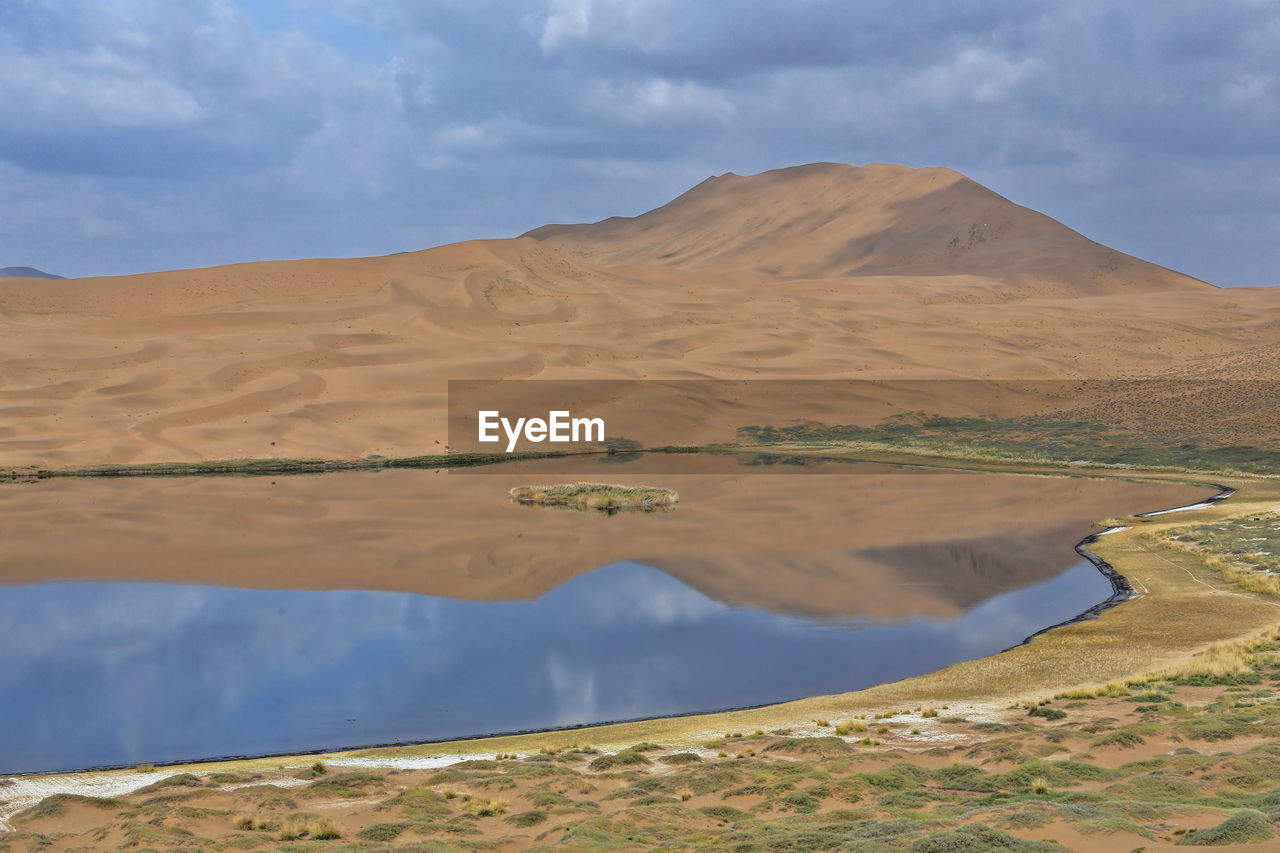 1078 lake zhalate-badain jaran desert-nomadic yurts-dune and sky reflection. inner mongolia-china.