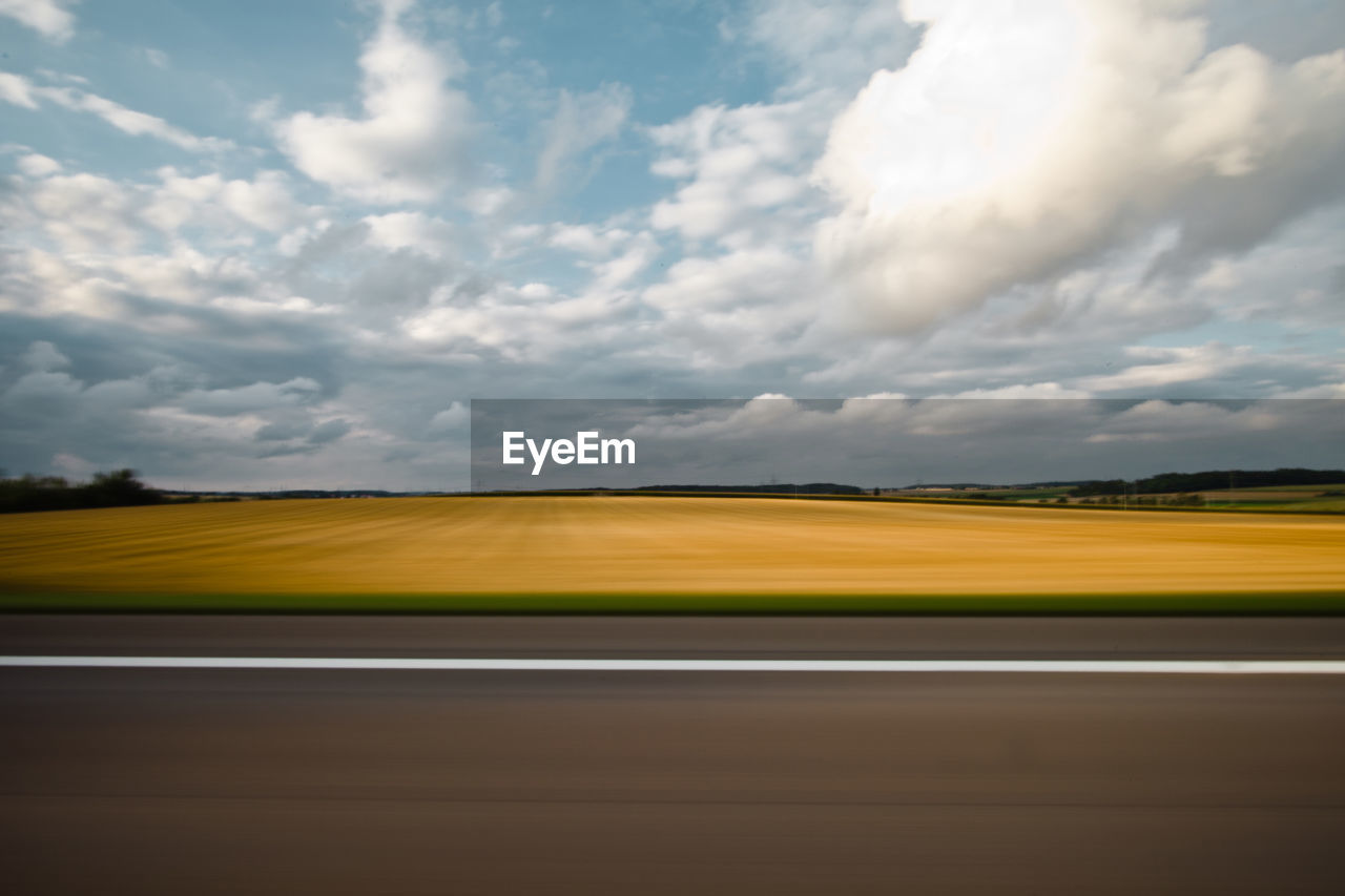 SCENIC VIEW OF ROAD BY LAND AGAINST SKY