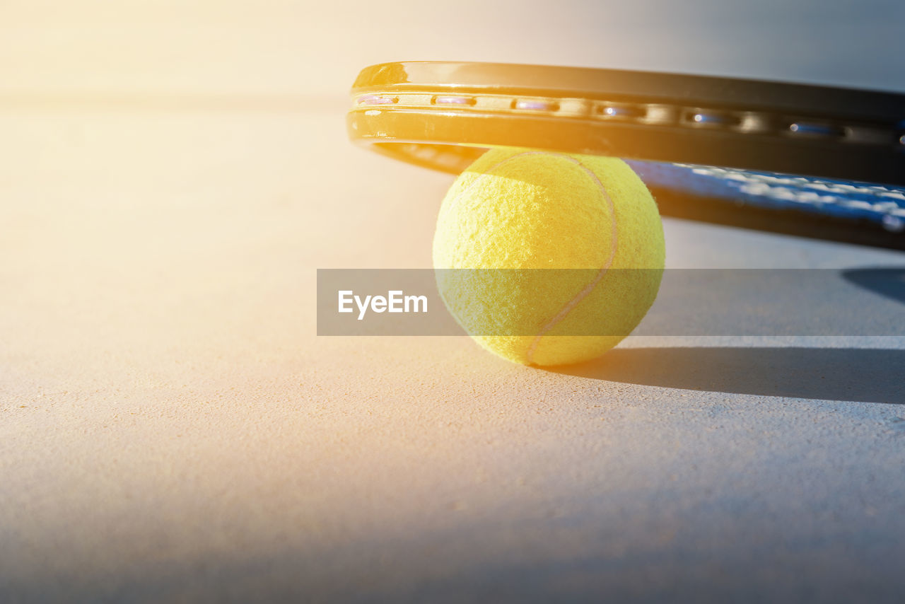 Close-up of tennis ball and racket