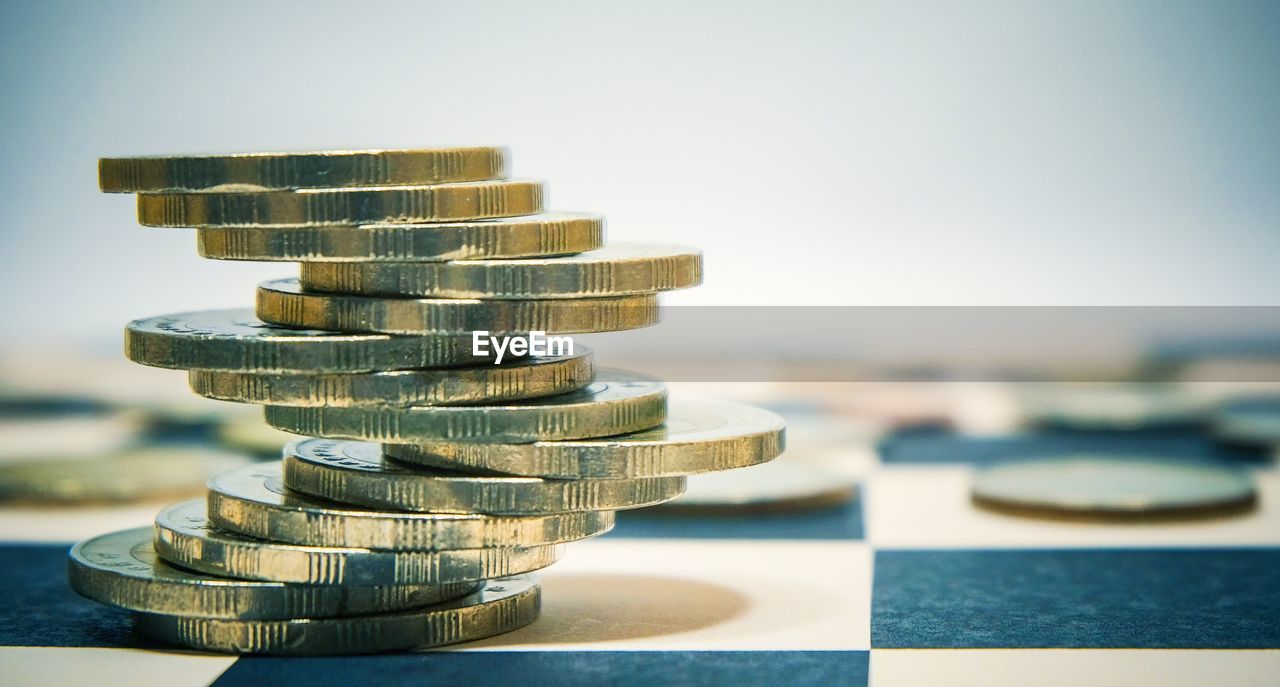 Close-up of coins stacked on table