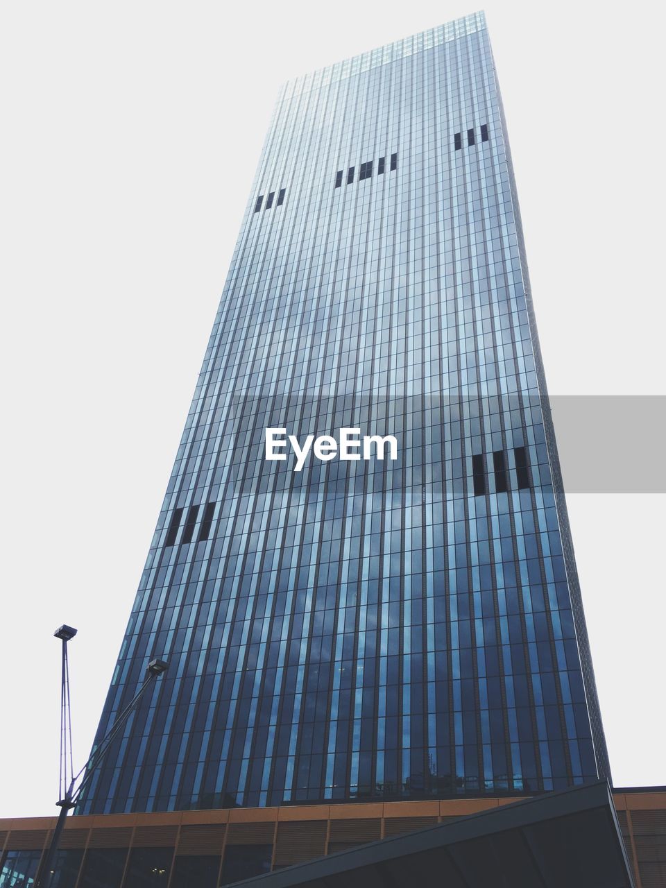 Low angle view of tall building against clear sky