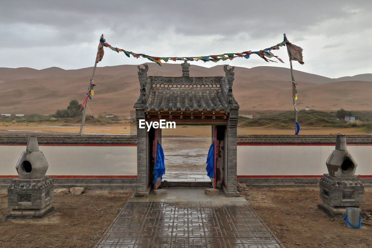 1116 buddhist prayer flags lung ta-e..facing arch-badain jaran desert temple. inner mongolia-china.