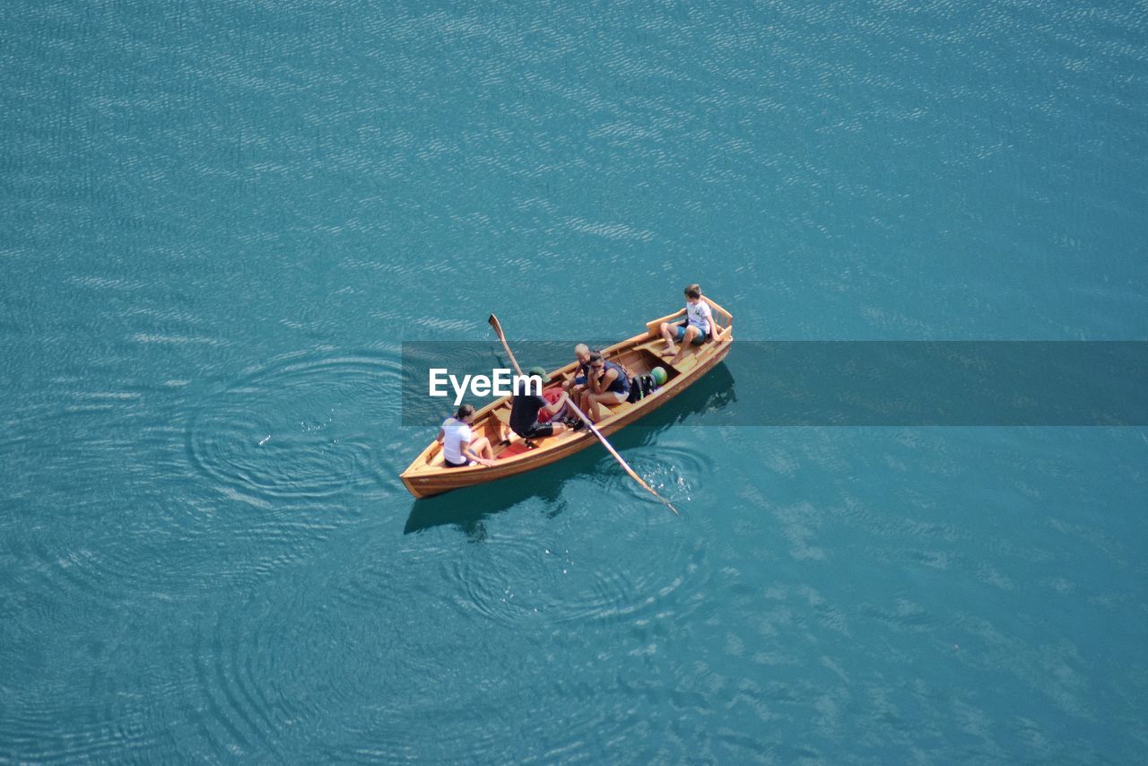 Aerial view of people sailing in boat at lake