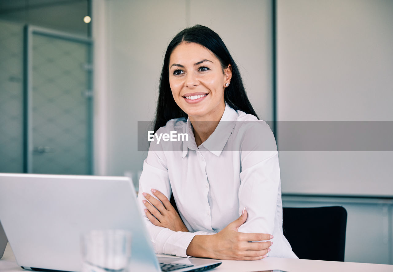 Smiling businesswoman sitting in office