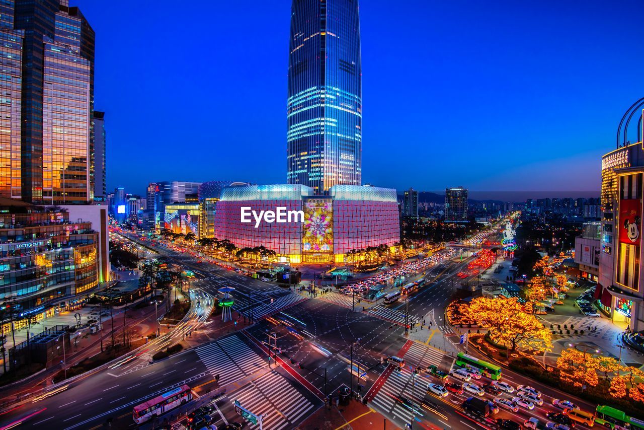 AERIAL VIEW OF ILLUMINATED CITY BUILDINGS AT NIGHT