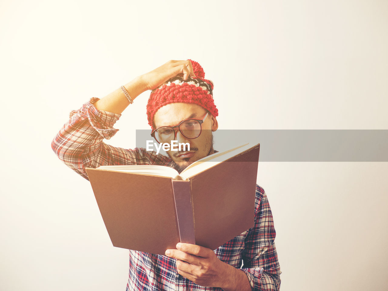 YOUNG MAN HOLDING BOOK