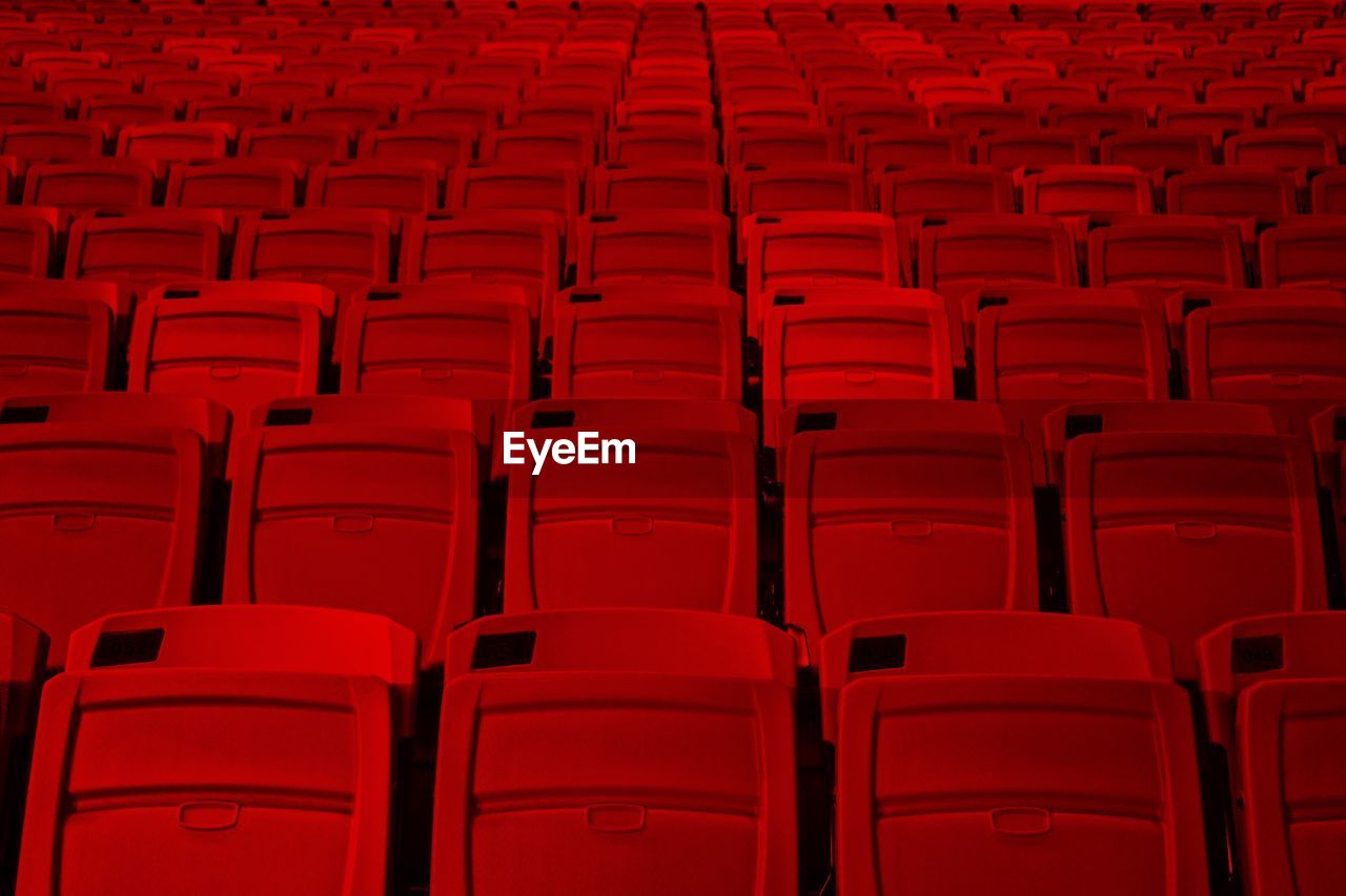 FULL FRAME SHOT OF RED SEATS IN ROW