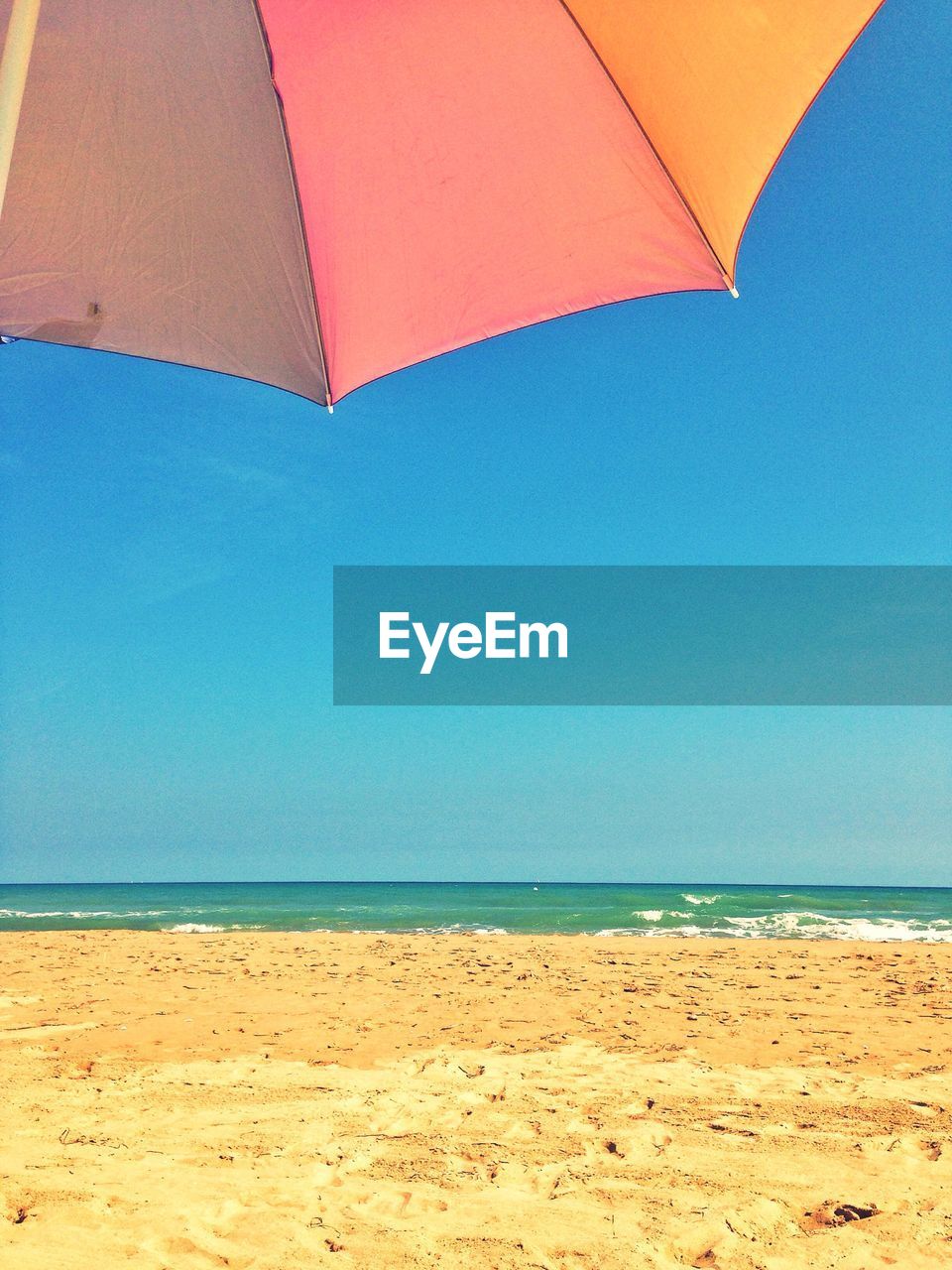 View of beach against blue sky