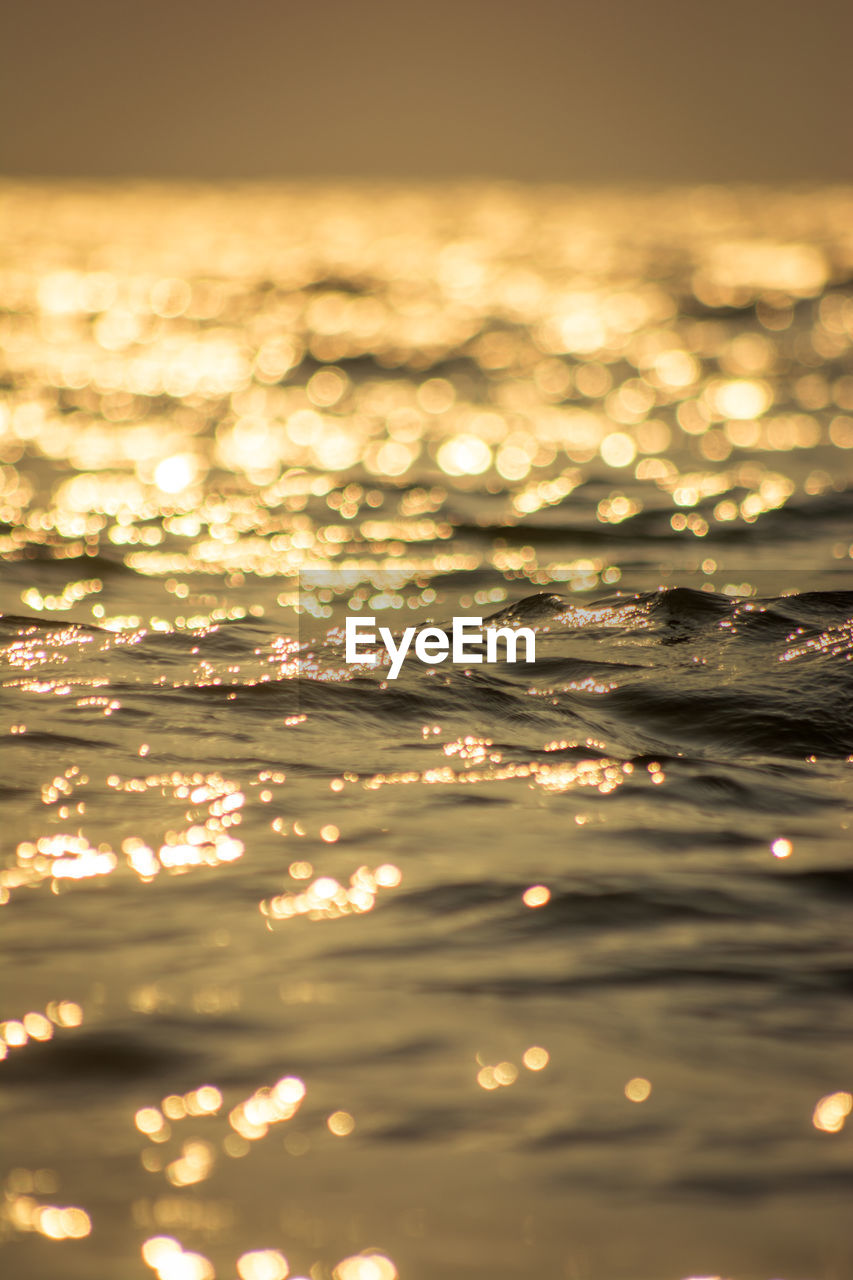 Close-up of sea against sky during sunset