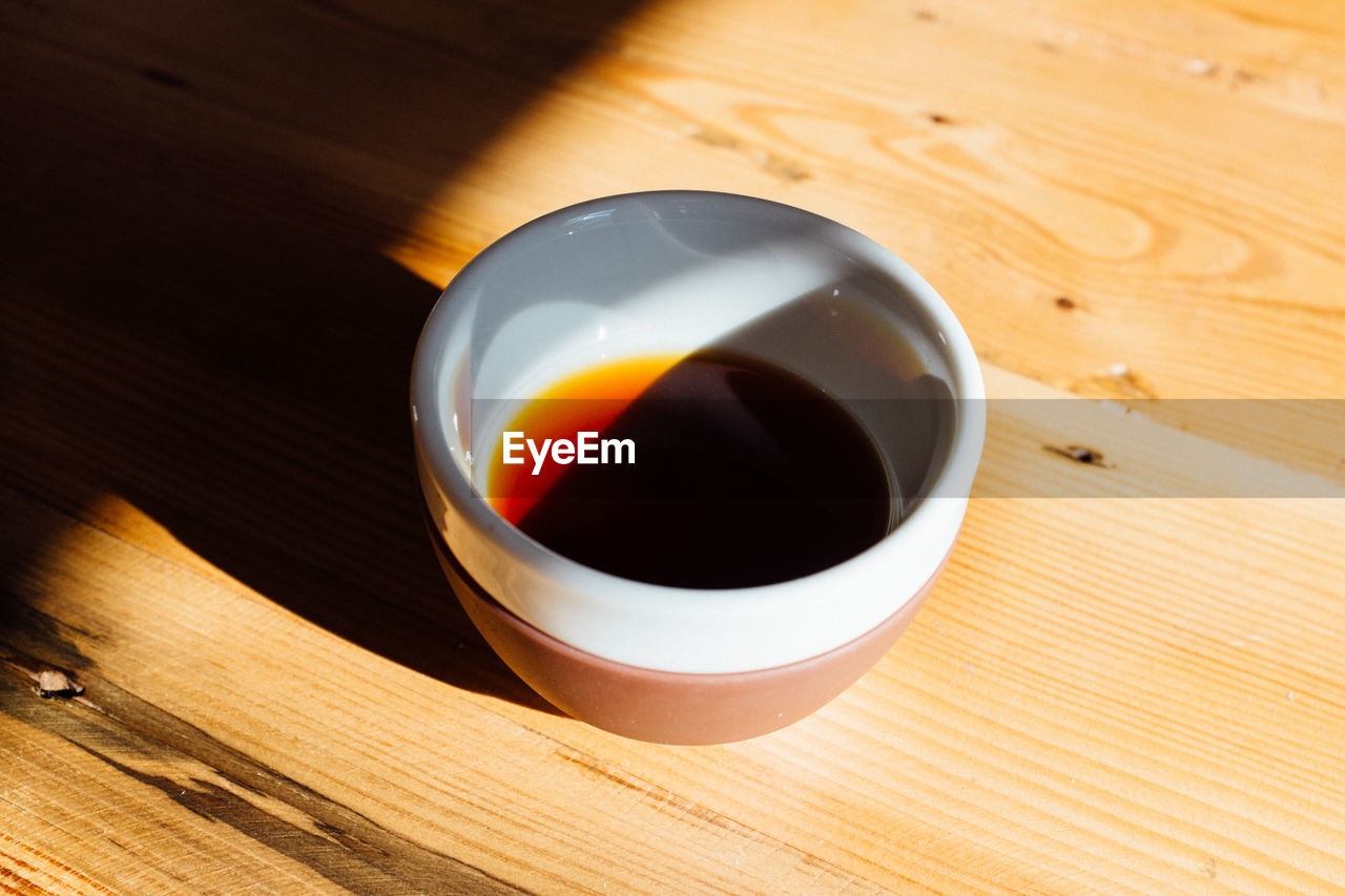 Close-up of coffee cup on wooden table