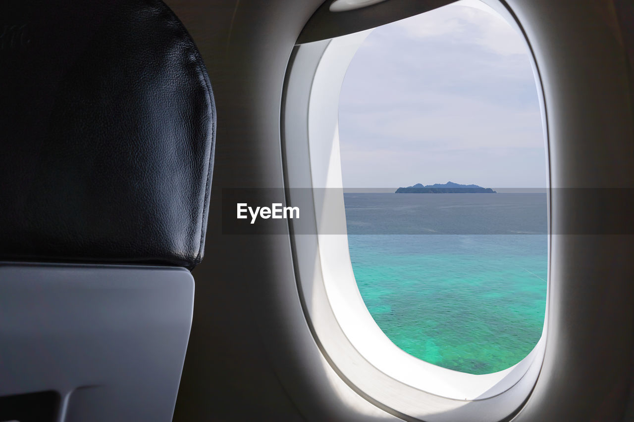 View of sea seen through airplane window