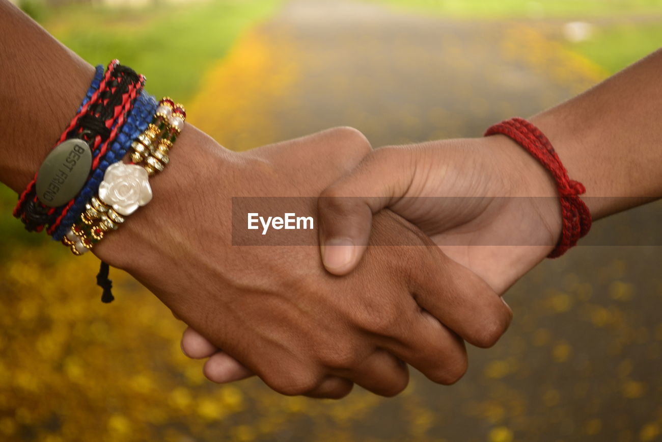 Close Up Of Friends Shaking Hands Id 110107145