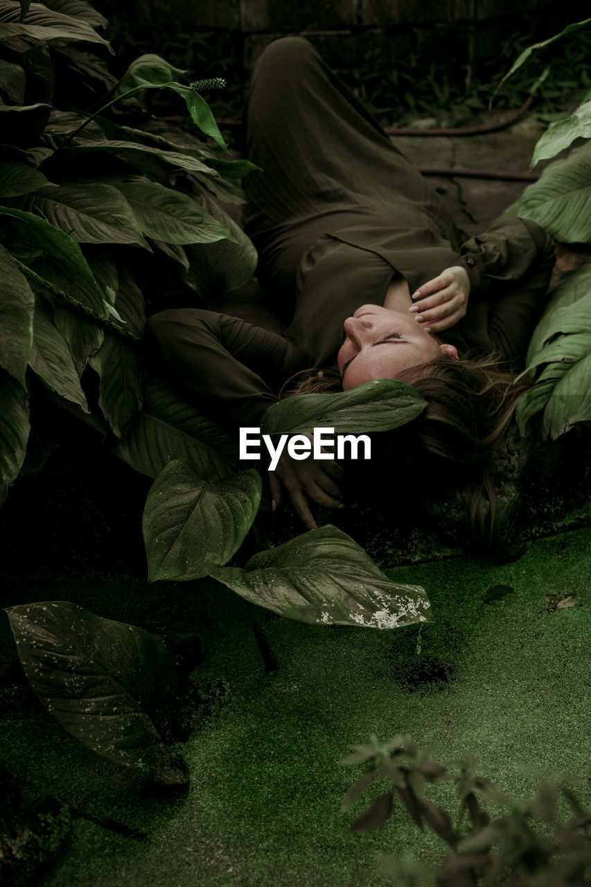 Woman lying down by plants