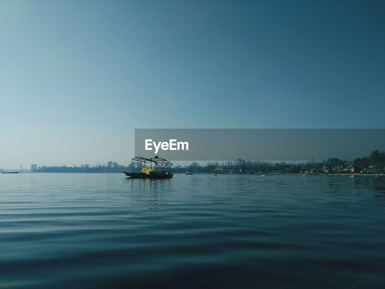 VIEW OF BOAT IN SEA AGAINST CLEAR SKY