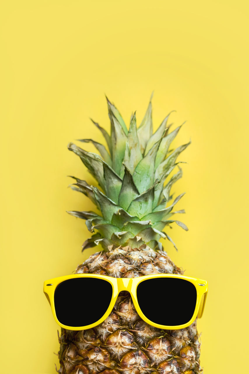 close-up of pineapple against orange background