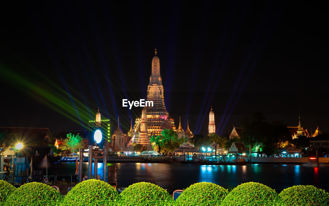 ILLUMINATED BUILDINGS AT WATERFRONT