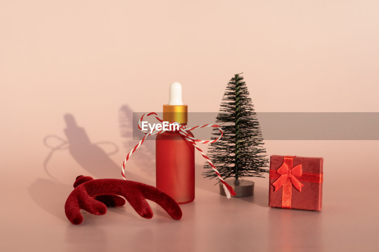 CHRISTMAS DECORATION IN BOX AGAINST YELLOW BACKGROUND