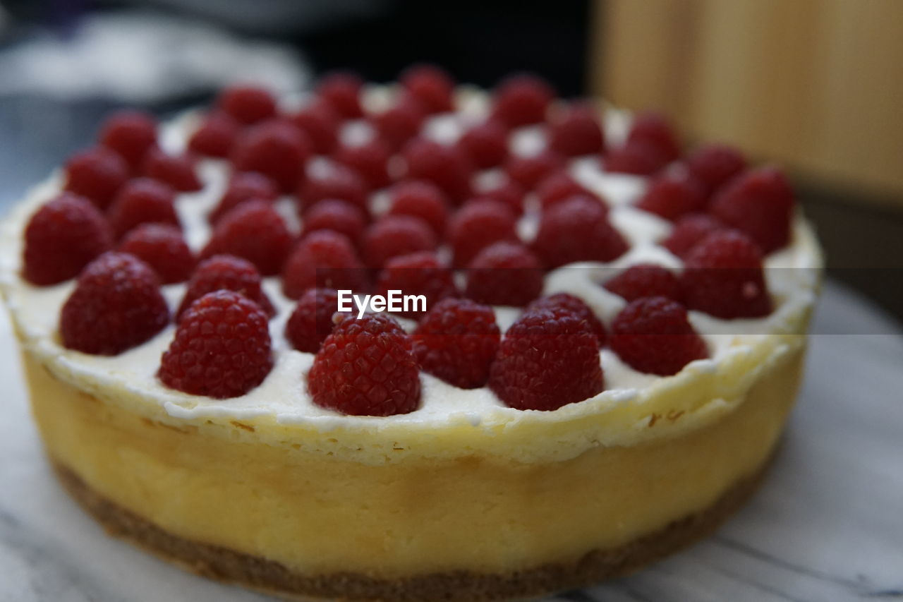 Close-up of cheesecake with raspberries in plate