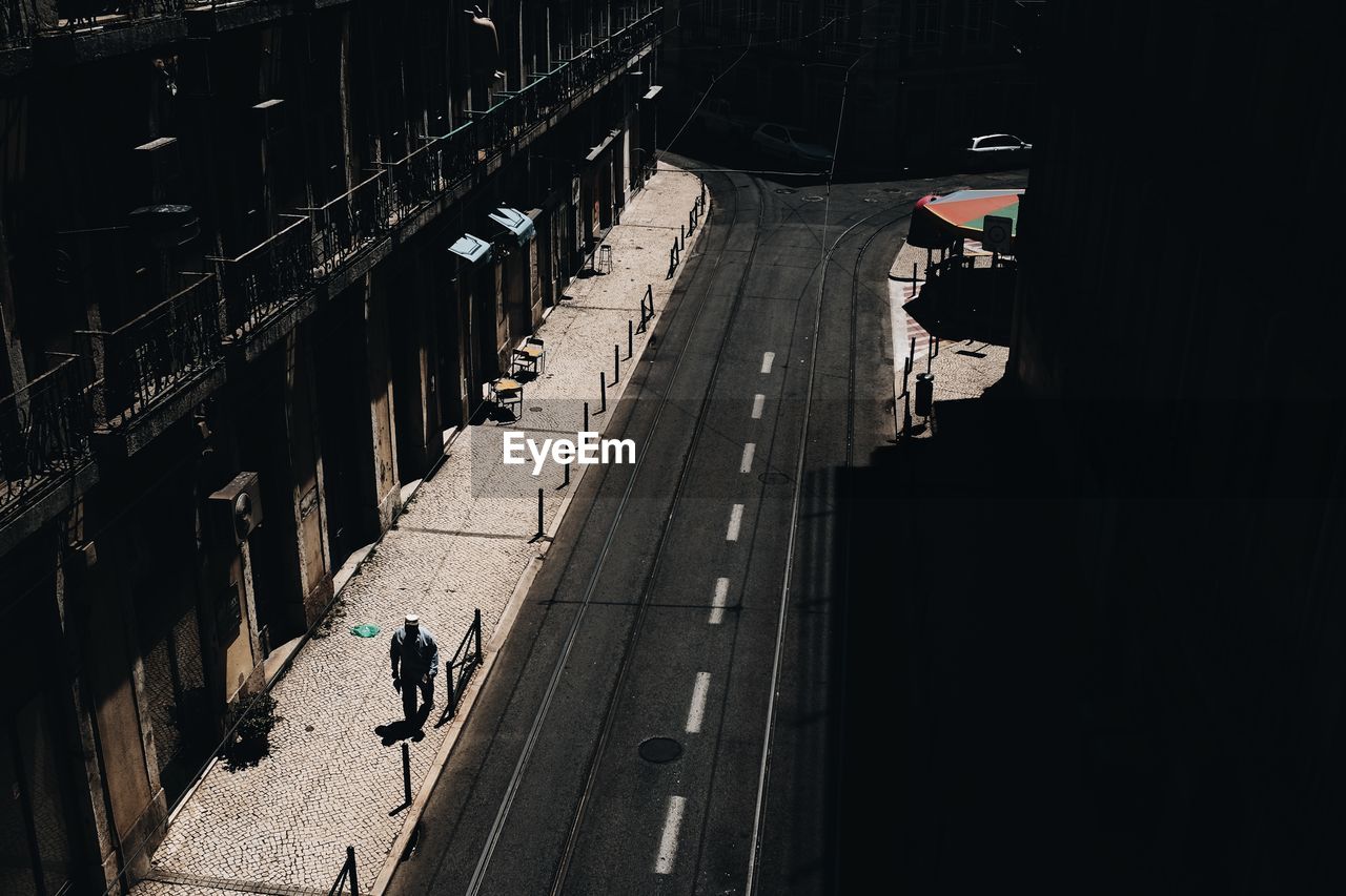 WOMAN WALKING ON CITY STREET