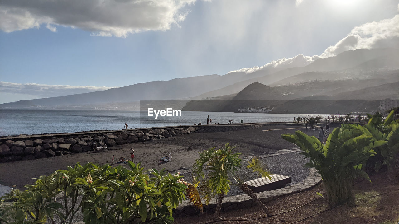 sky, water, cloud, nature, environment, sea, mountain, scenics - nature, coast, land, beauty in nature, landscape, travel destinations, travel, beach, shore, plant, ocean, tourism, tranquility, no people, body of water, outdoors, morning, day, bay, tranquil scene, panoramic, mountain range, sunlight, holiday, vacation, trip, transportation, non-urban scene, sun