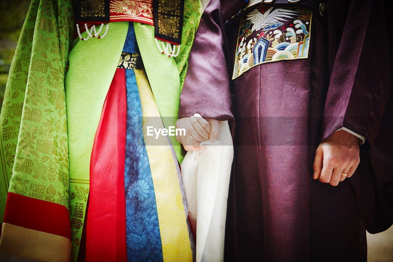 Midsection of wedding couple wearing hanbok