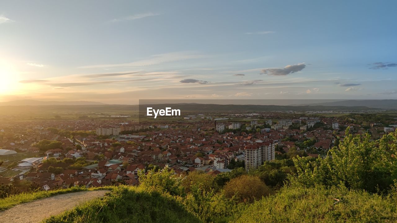 Aerial view of townscape against sky at sunset