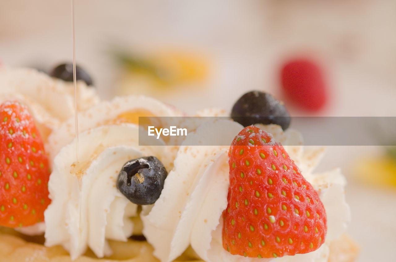 Berries and whipped cream on waffle