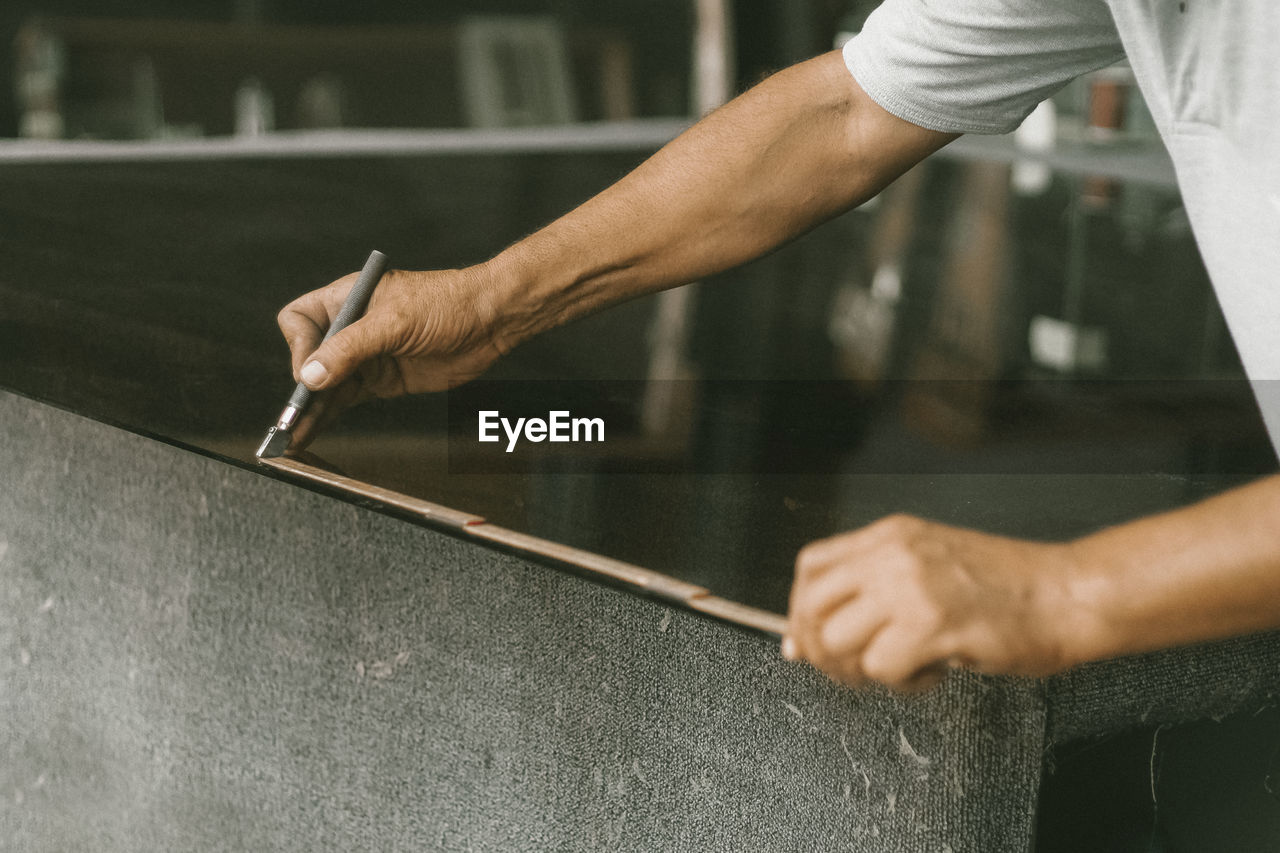 Midsection of carpenter measuring table