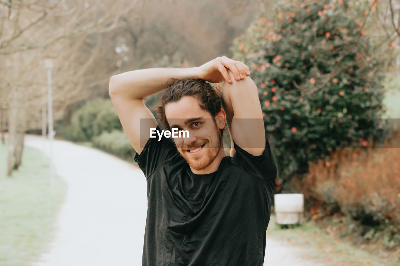 Portrait of smiling young man standing outdoors