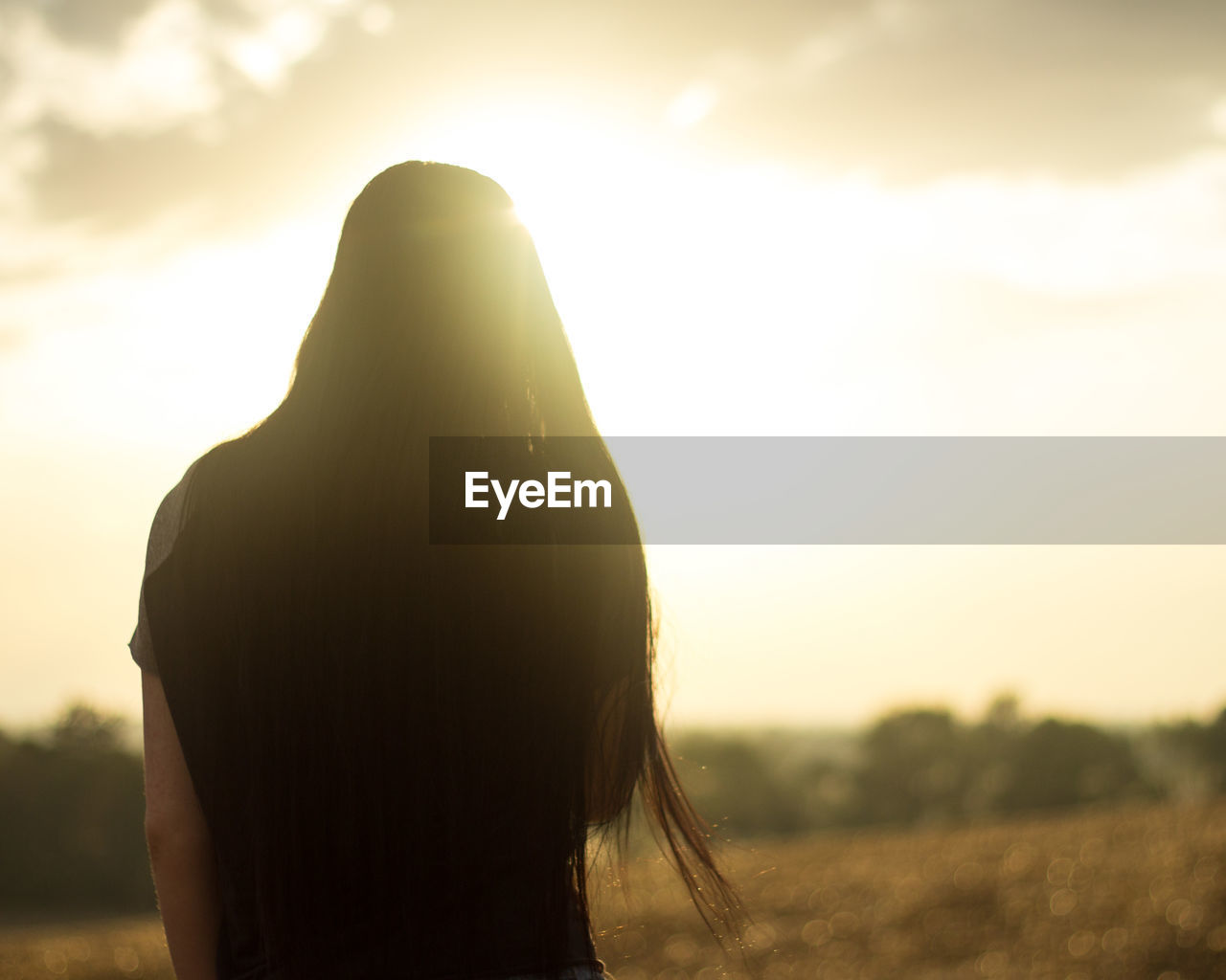 Rear view of woman standing against sky