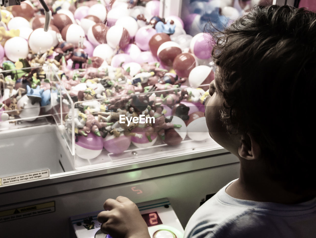 High angle view of boy playing arcade game