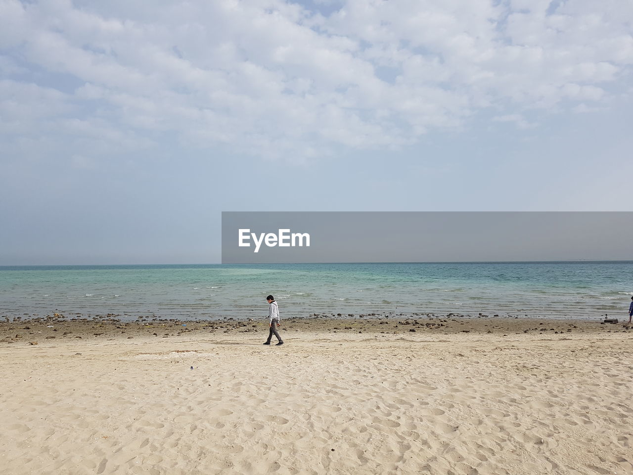 Boy walking at beach