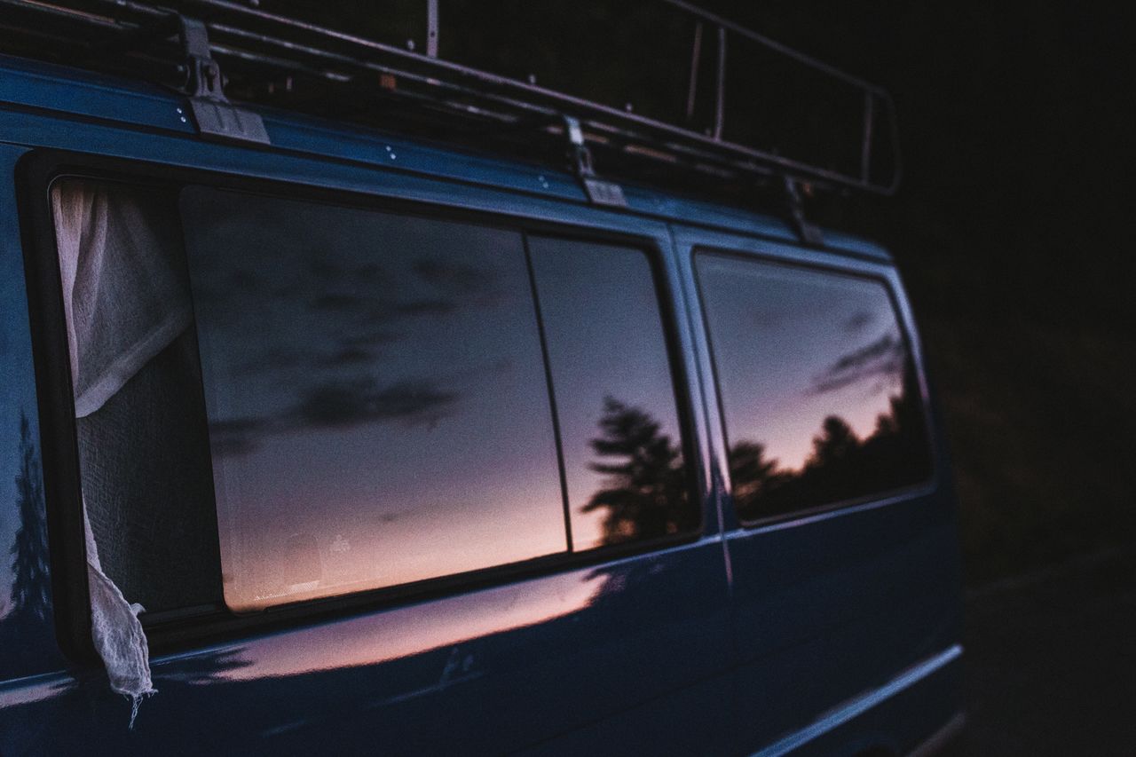 Van window with reflection of sky during sunset