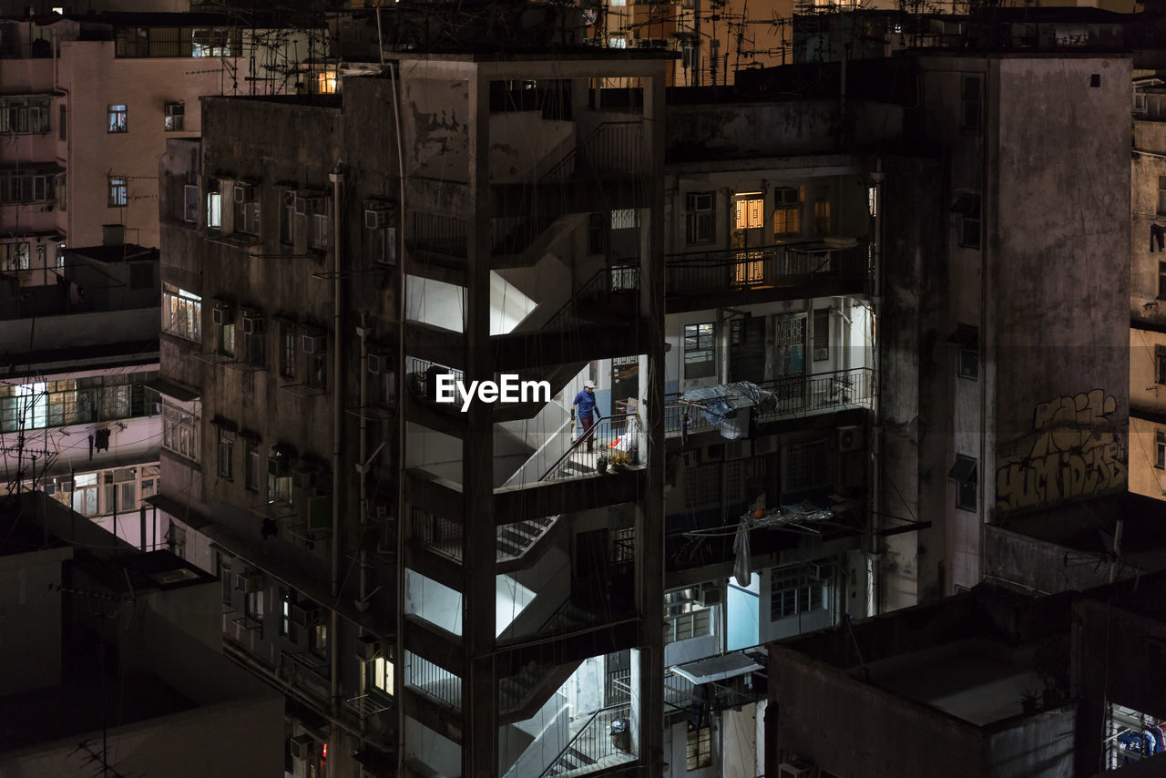High angle view of residential buildings in city at night