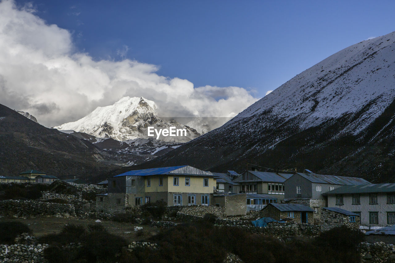 Island peak seen behind a village in nepal's khumbu valley.