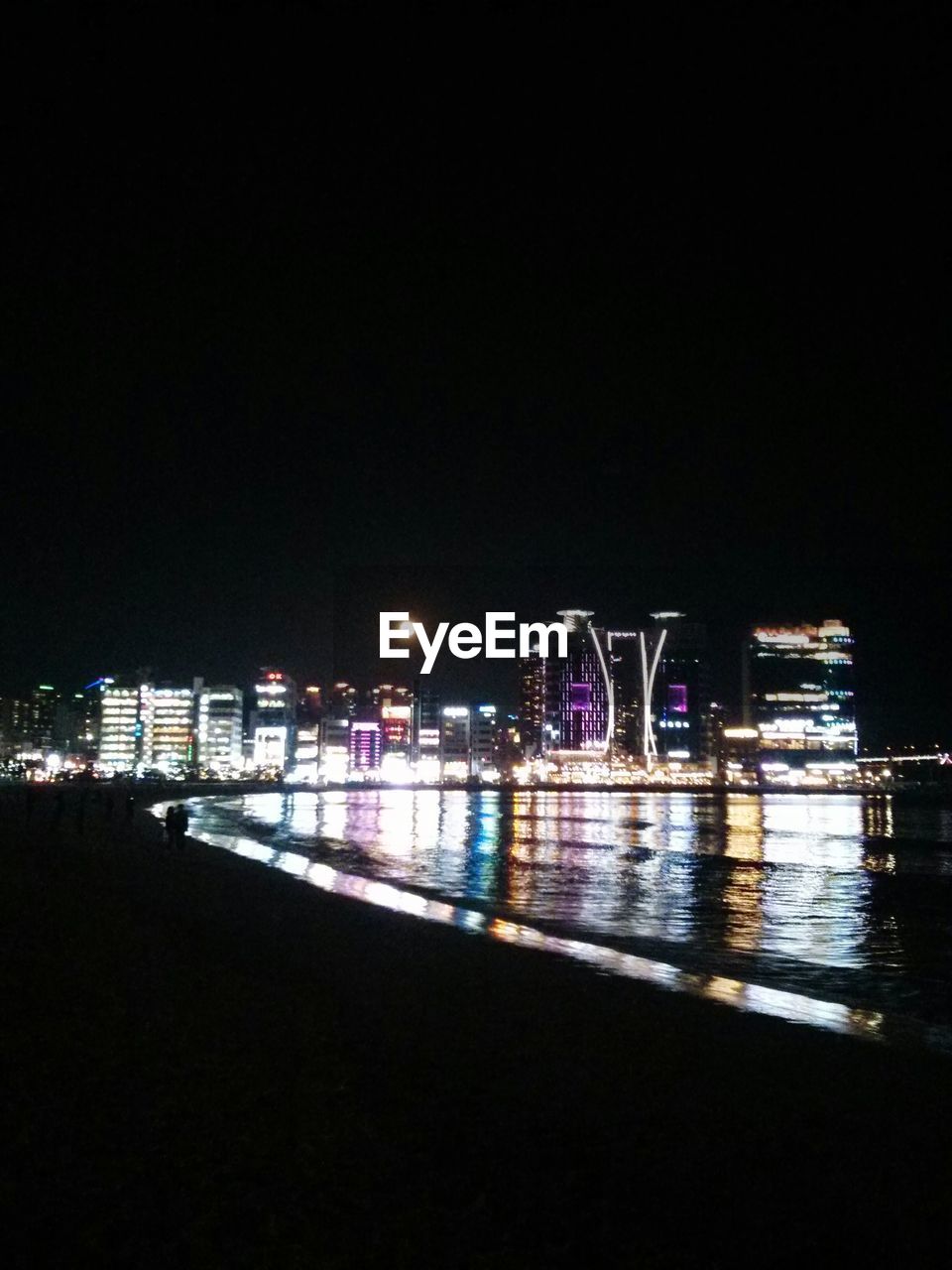 VIEW OF ILLUMINATED CITY AT NIGHT