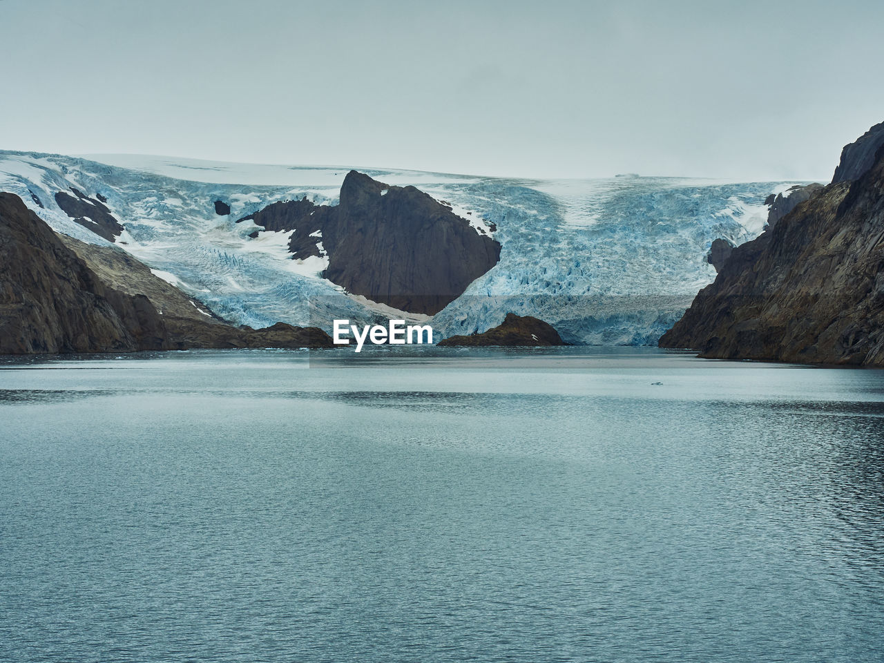 water, scenics - nature, cold temperature, environment, beauty in nature, landscape, mountain, sea, ice, snow, sky, glacial landform, winter, glacier, nature, tranquil scene, ocean, frozen, tranquility, land, lagoon, travel destinations, coast, mountain range, bay, no people, travel, non-urban scene, iceberg, blue, glacial lake, extreme terrain, outdoors, idyllic, remote, day, tourism, rock, cloud, polar climate
