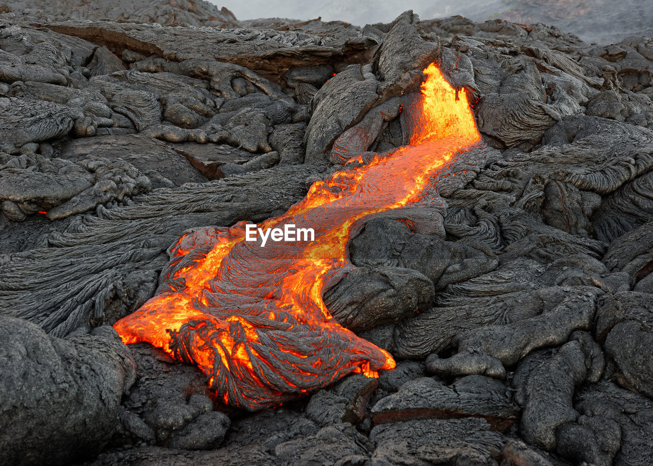 Hot magma of an active lava flow emerges from a fissure, hawaii, big island, kilauea, kalapana
