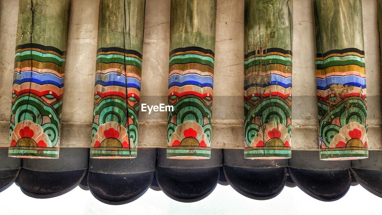 Upside down image of painted wooden poles