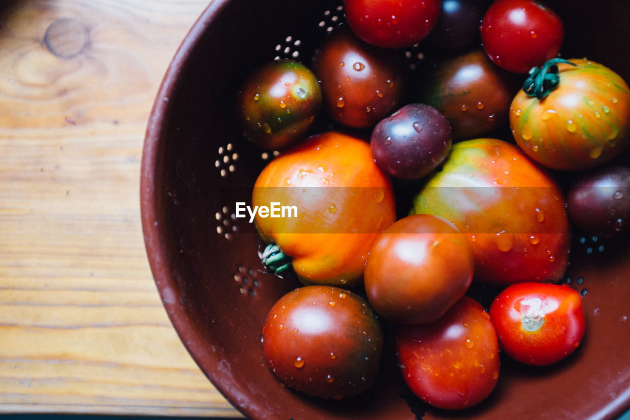 High angle view of wet tomatoes in container
