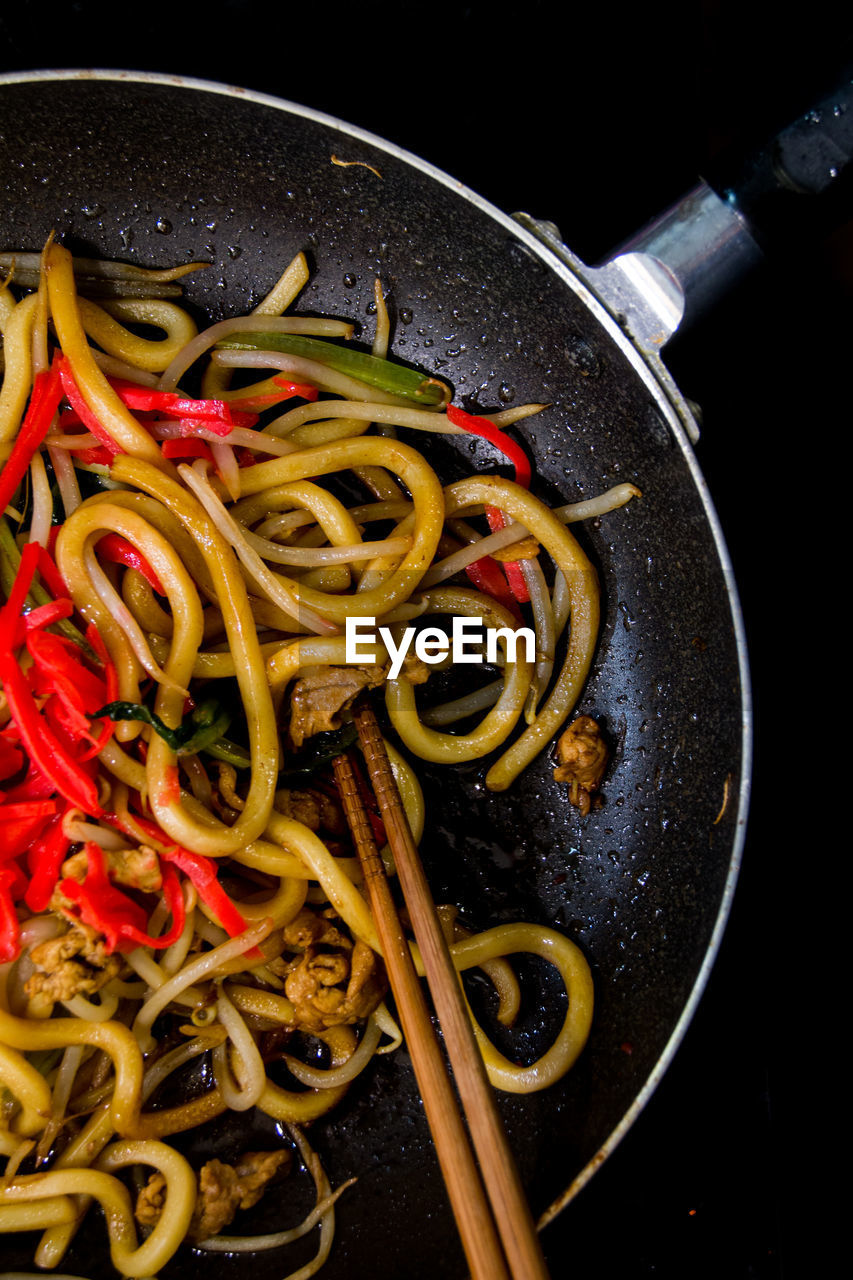 Close-up of udon noodles in cooking pan